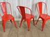 red stacking tolix style chairs